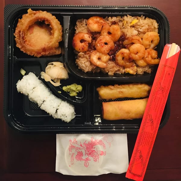 Shinrai Japanese Bistro's bento box with shrimp fried rice, sushi, onion ring, and egg rolls.